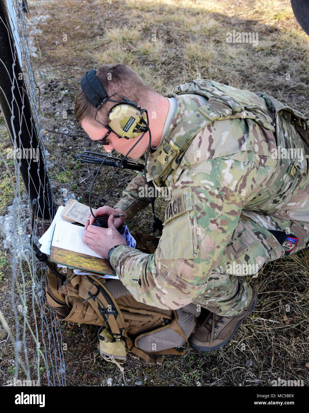 A Joint Terminal Attack Controller from the 7th Air Support Operations Squadron, located in Fort Bliss, Texas, writes down information during a joint training at Warsaw, Mo., Jan. 31, 2018. JTACs are personnel who are authorized to call airstrikes and help coordinate close-air-support missions. (U.S. Air Force by Staff Sgt. Danielle Quilla) Stock Photo