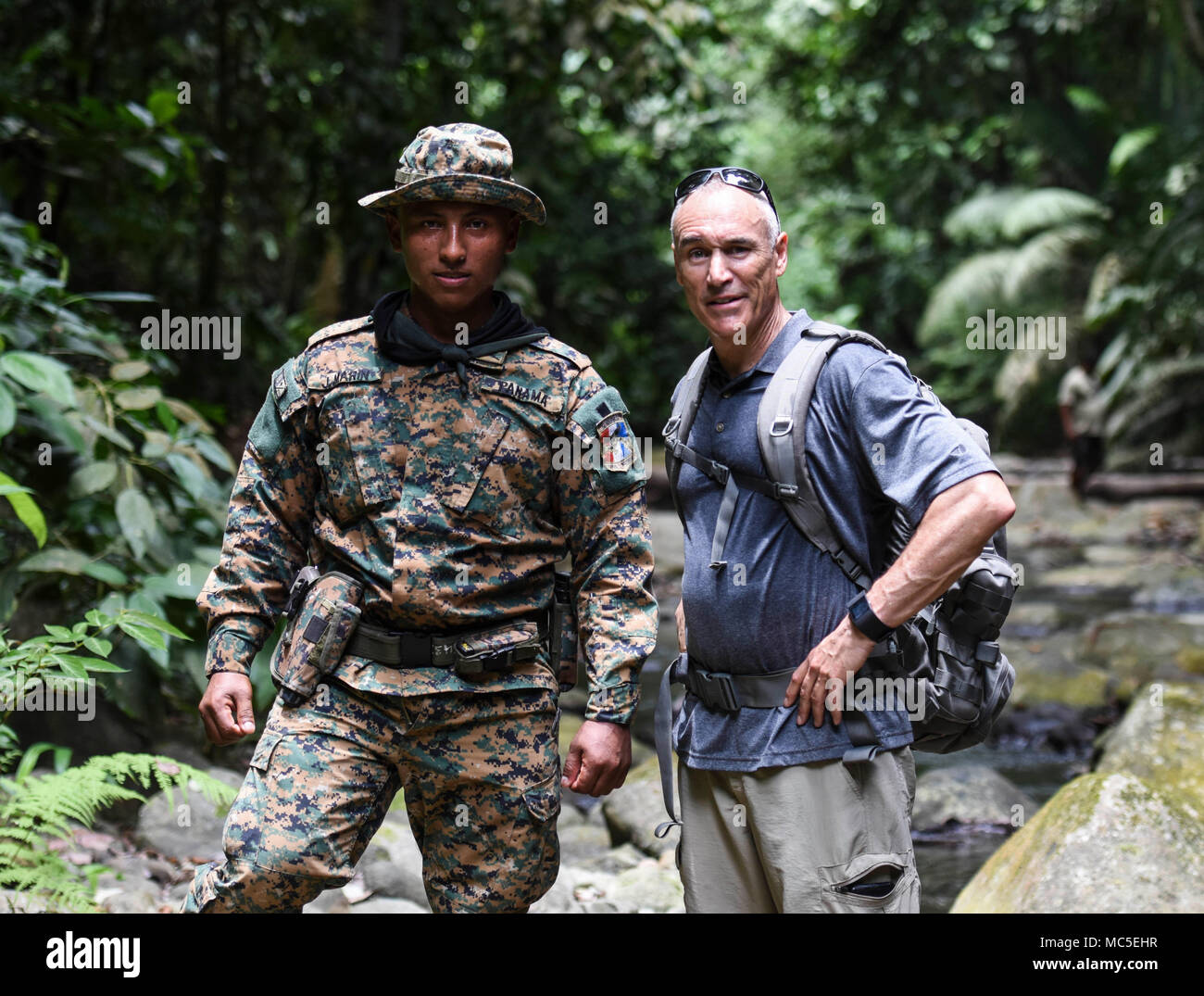 U.S. Air Force Chief Master Sgt. Scott Robbins, 346th Air Expeditionary Group superintendent, stands for a photo with a member of the Panamanian military and police force known as SENAFRONT, while hiking in the Darien National Park, Panama, April 2, 2018, during exercise New Horizons 2018. Exercise New Horizons is a joint training exercise where all branches of the U.S. military conduct training in civil engineer, medical and support services while benefiting the local community. (U.S. Air Force photo by Senior Airman Dustin Mullen/Released) Stock Photo