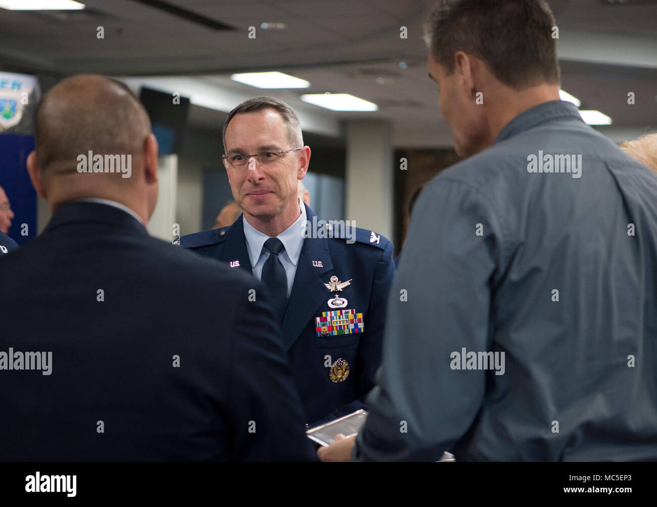 Col. Christopher Povak, Aerospace Data Facility - Colorado commander, converses with newly inducted honorary commanders during the induction ceremony April 3, 2017 on Buckley Air Force Base, Colorado. The Buckley AFB Honorary Commander Program’s purpose is to identify common interests between civilian and military life, and aims to support community efforts and to work together to solve mutual problems. (U.S. Air Force photo by Airman 1st Class Holden S. Faul) Stock Photo