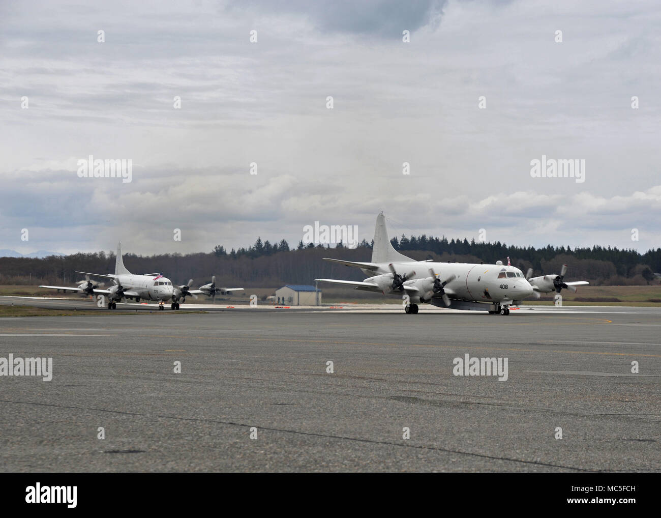 180403-N-KG618-216 OAK HARBOR, Wash. (April 3, 2018) Two P-3 Orion aircrafts assigned to Patrol Squadron (VP) 40 pull into hangar 6 at Naval Air Station Whidbey Island (NASWI) upon returning from deployment to the U.S. 5th, 6th, and 7th Fleets areas of operations. VP-40 is a maritime patrol squadron assigned to Patrol and Reconnaissance Wing 10 and is stationed at NASWI.  (U.S. Navy photo by Mass Communication Specialist 2nd Class Kevin A. Flinn/Released) Stock Photo