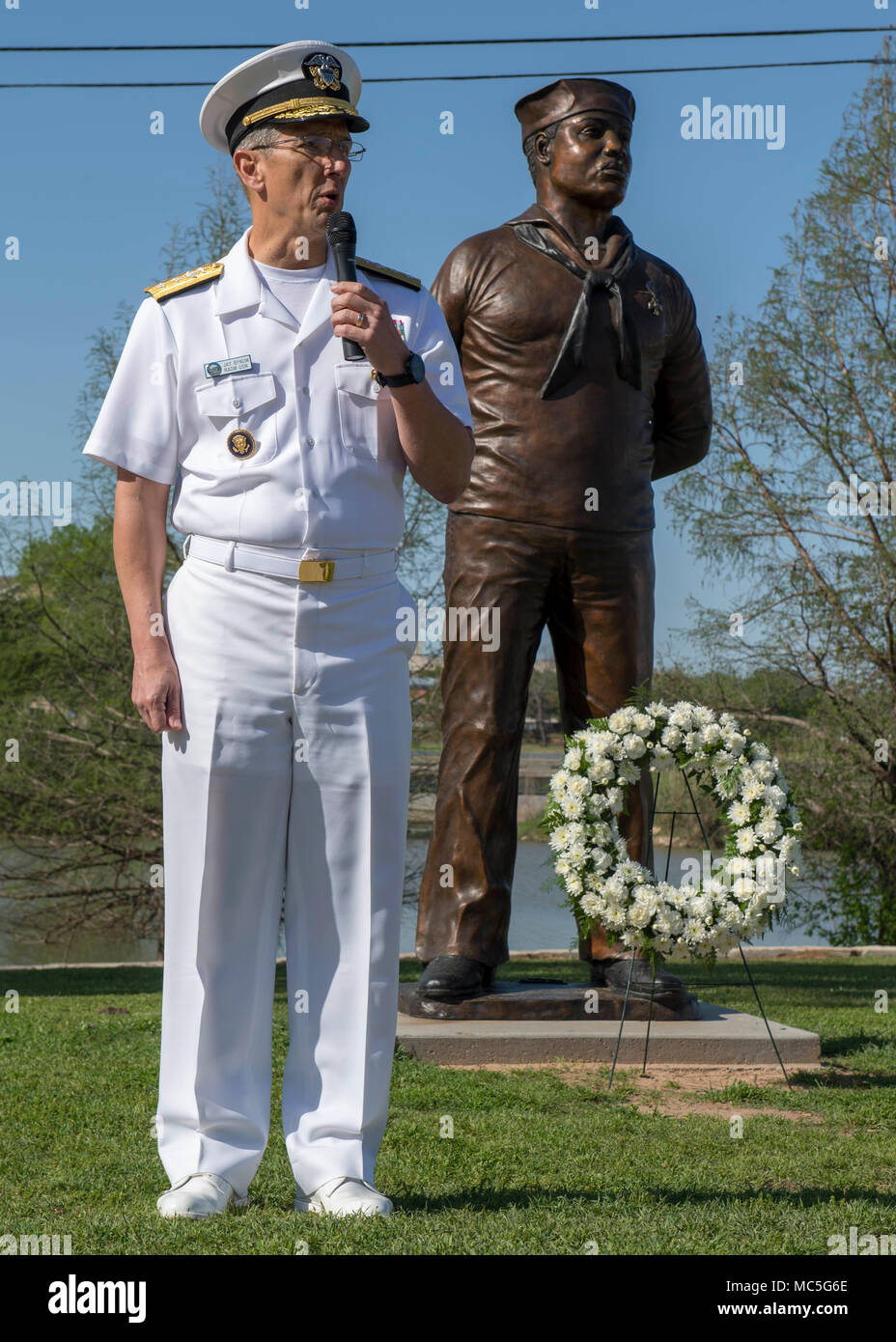 180404-N-YR245-0055 WACO, Texas (April 4, 2018) Rear Adm. Jay Bynum, Chief of Naval Air Training and Waco native, speaks at a ceremony honoring Doris “Dorie” Miller on the Waco Riverwalk during Waco Navy Week. The Navy Office of Community Outreach uses the Navy Week program to bring Navy Sailors, equipment and displays to approximately 15 American cities each year for a week-long schedule of outreach engagements. (U.S Navy photo by Mass Communication Specialist 2nd Class Craig Z. Rodarte/Released) Stock Photo