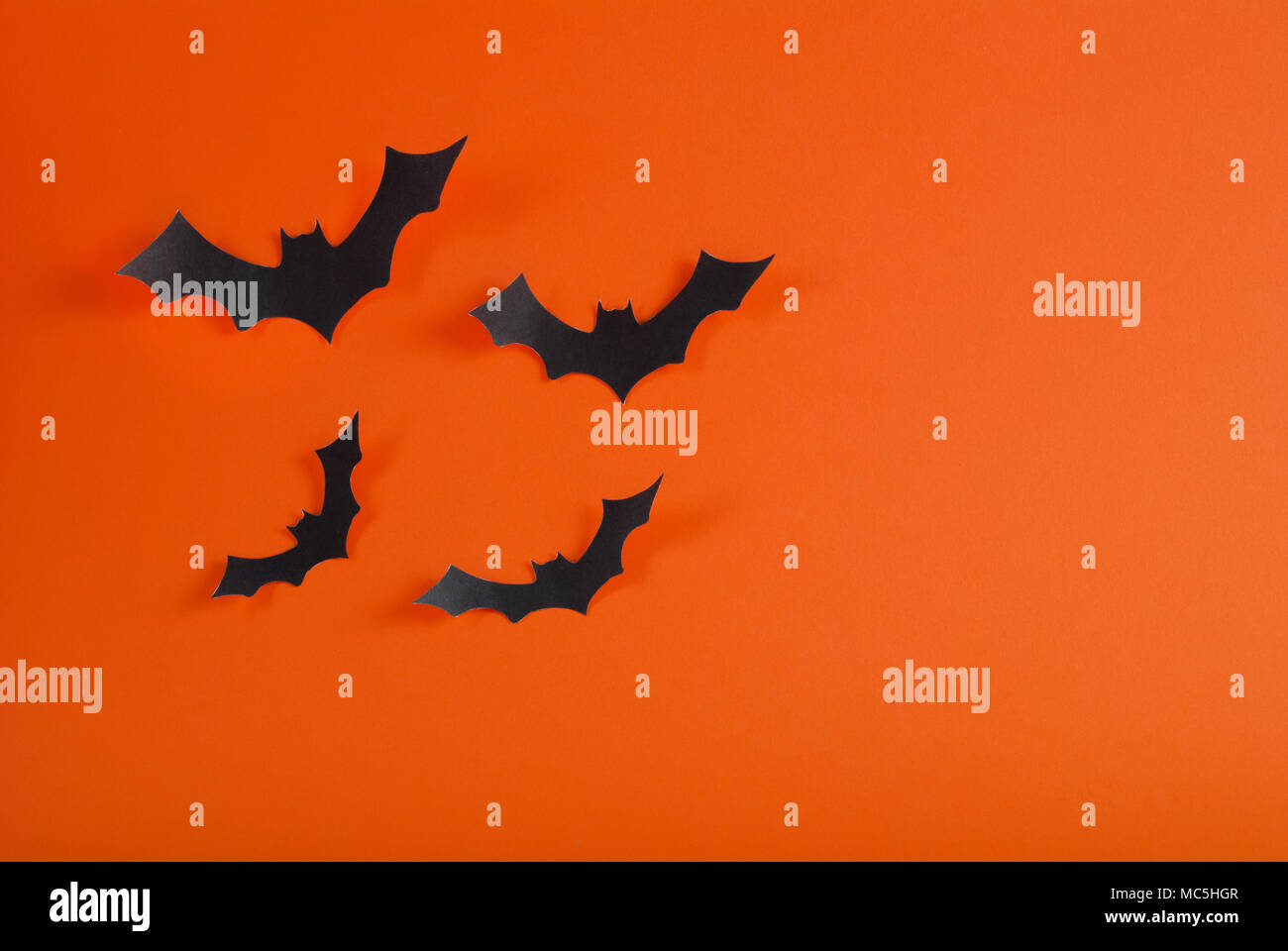 Bats flying on orange background with space for design. Halloween concept. Stock Photo