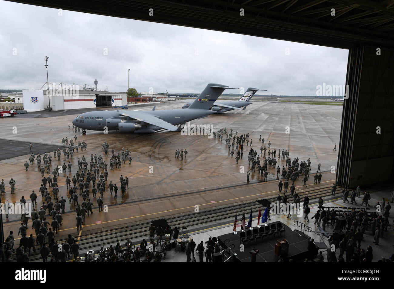 Members from the 145th Airlift Wing walk onto the flight line after the ...