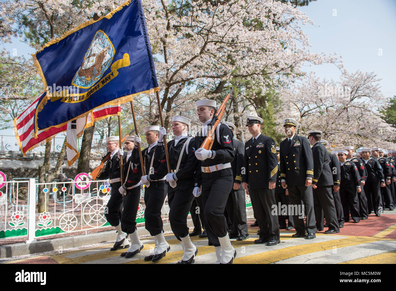 180406-N-TB148-050 CHINHAE, Republic of Korea (April 06, 2018) Sailors assigned to Commander, Fleet Activities Chinhae (CFAC), and Commander, U.S. Naval Forces Korea (CNFK) participate in the Jinhae Military Parade Festival also known as the Jinhae Cherry Blossom Festival in Changwon. In commemoration of famed ROK naval hero Admiral Yi Sun-shin the ten-day festival coincides with the annual spring bloom of the cherry blossom trees which attract over 2 million visitors. (U.S. Navy photo by Mass Communication Specialist Seaman William Carlisle) Stock Photo