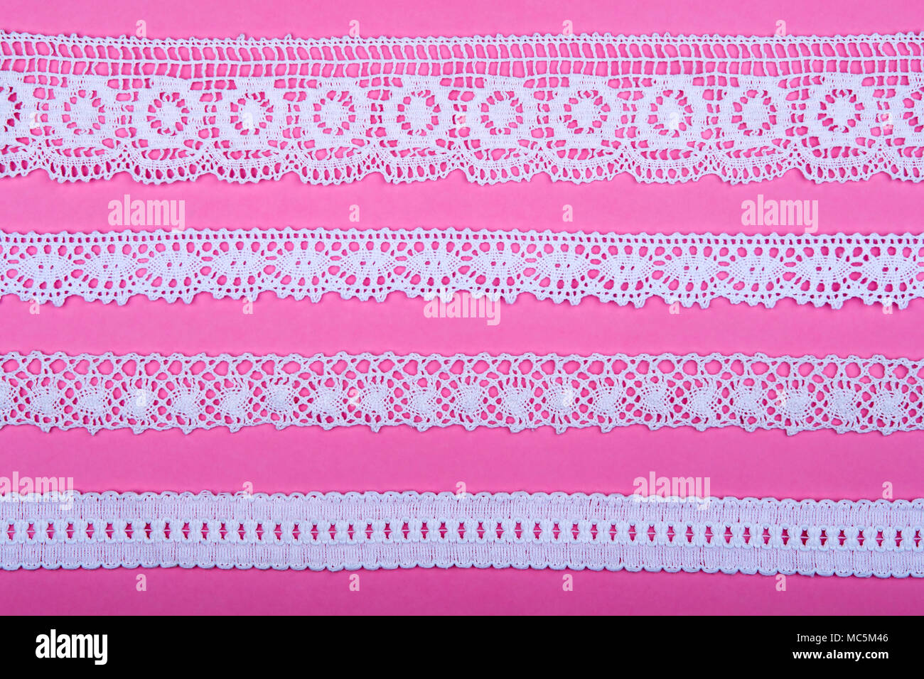 4 different lace borders against pink background. Stock Photo