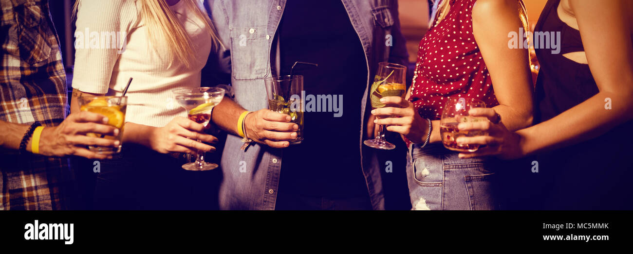 Mid section of friends holding drinks Stock Photo
