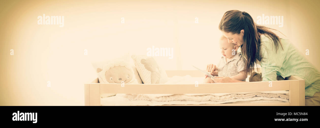 Mother using digital tablet with baby boy Stock Photo
