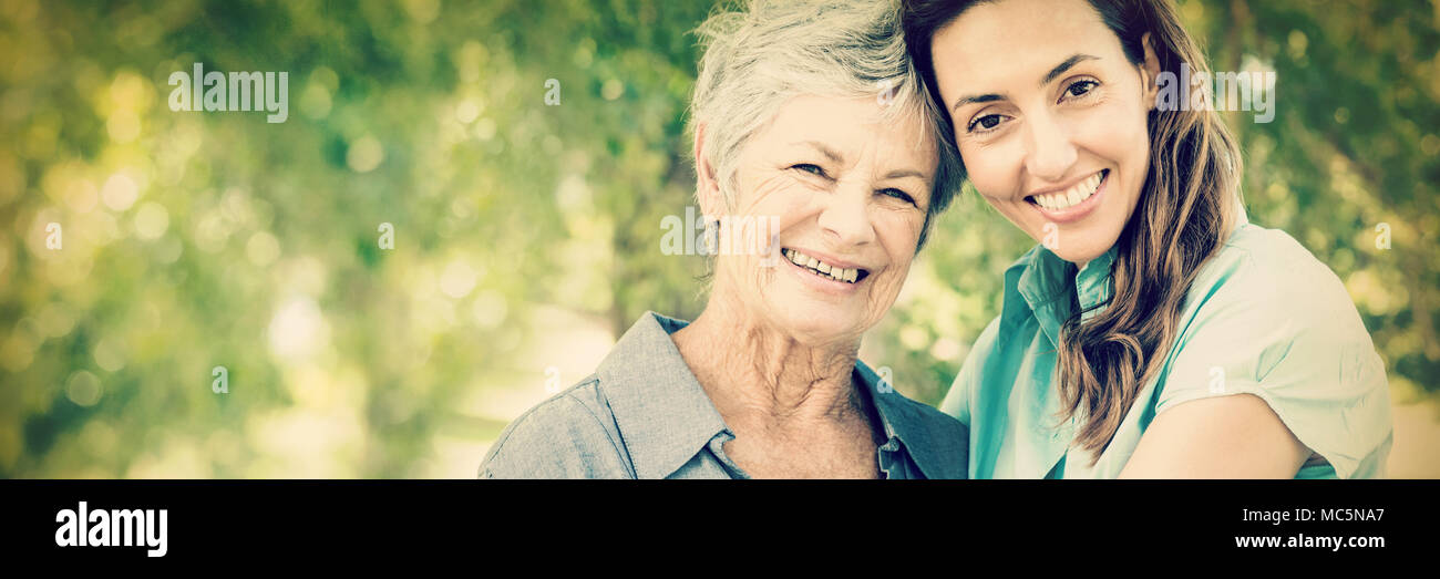 Mother and grandmother smiling in park Stock Photo