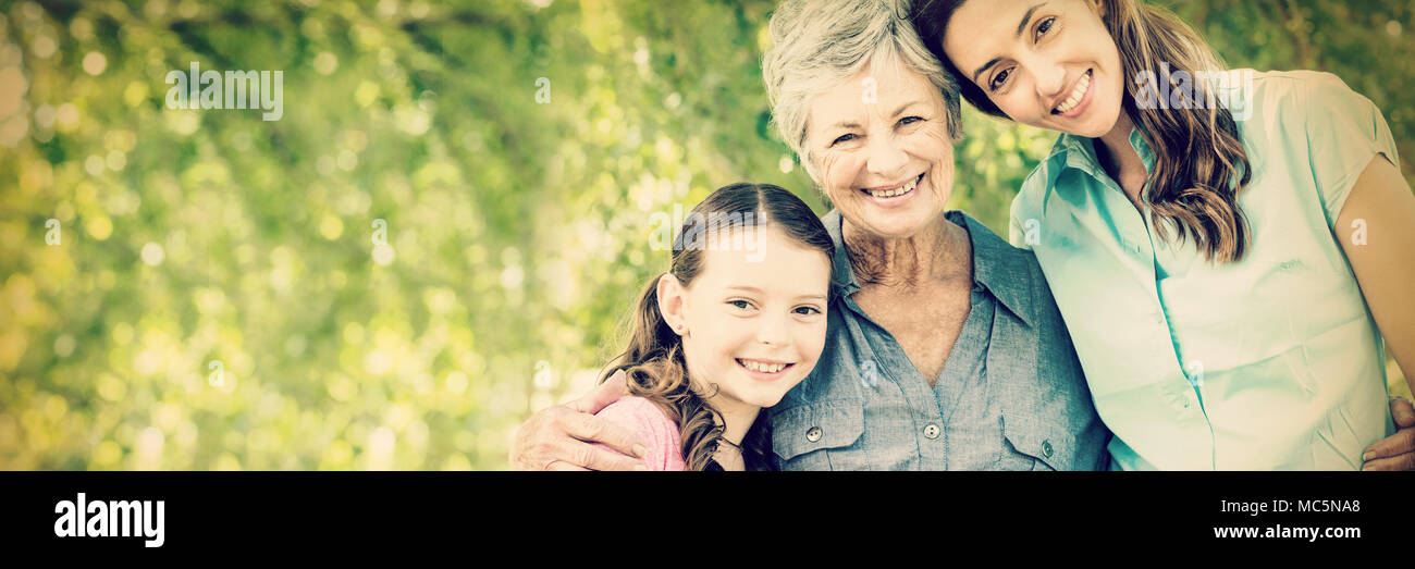 Extended family smiling in the park Stock Photo