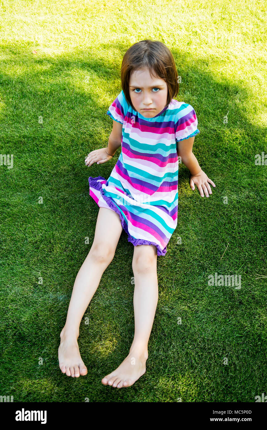 Outdoors portrait of small girl with offended look. Stock Photo