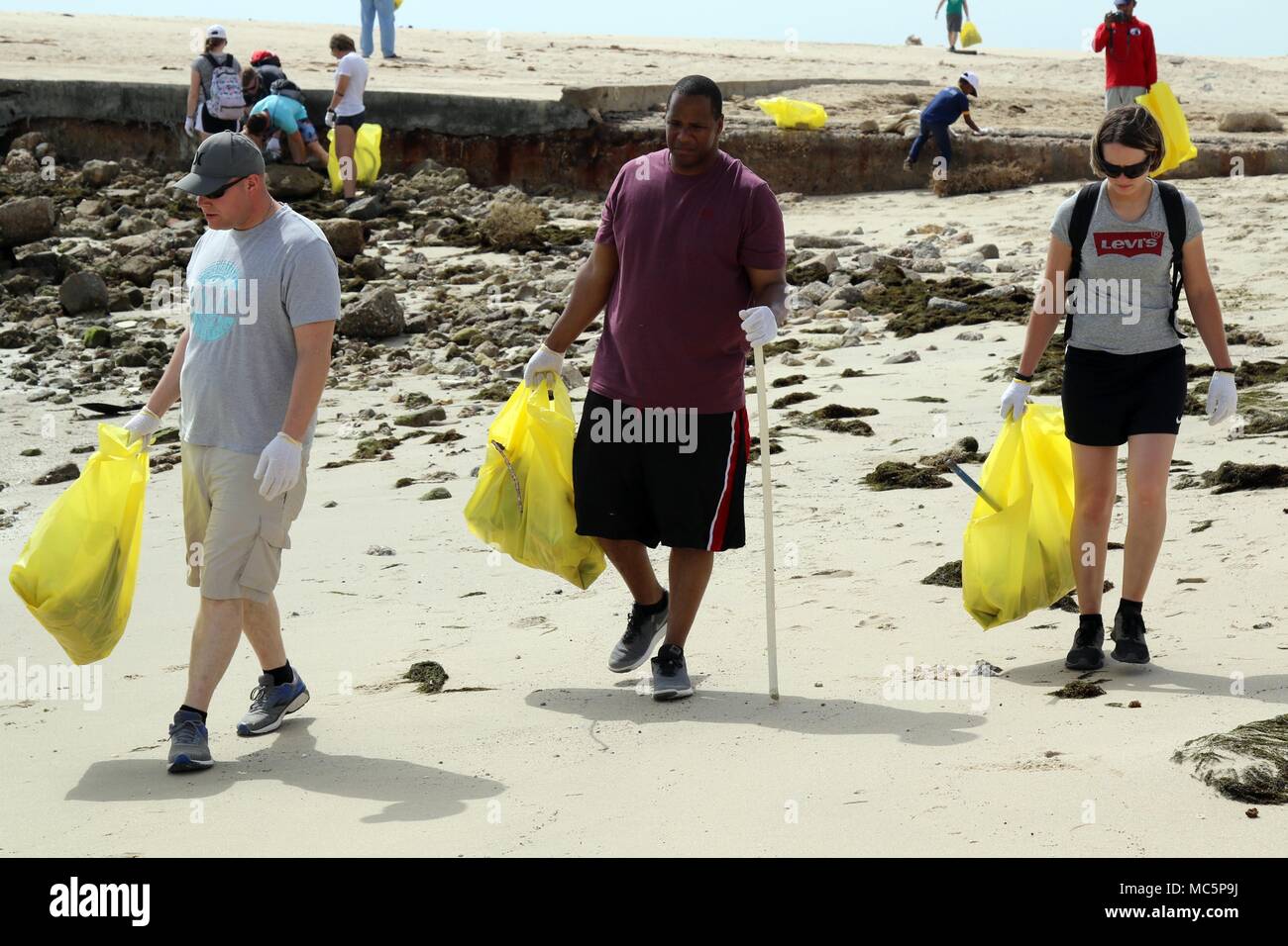 KUWAIT CITY, Kuwait — Sgt. Cameron Wiebelhaus (left) of Erie, Sgt. Raymond Parrish of Pittsburgh and Spc. Brooke King of Reedsville, Pa., clear a section of Anjafa Beach of trash during a cleanup event April 7, 2018. King is with Headquarters Support Company, Headquarters and Headquarters Battalion, 28th Infantry Division, Task Force Spartan. Parrish and Wiebelhaus are with Charlie Company. The Saturday morning cleanup was part of the Every Soldier an Ambassador (ESA) program and provided a morale-boosting trip that took Soldiers off post and into the local community for a common cause.  (U.S. Stock Photo