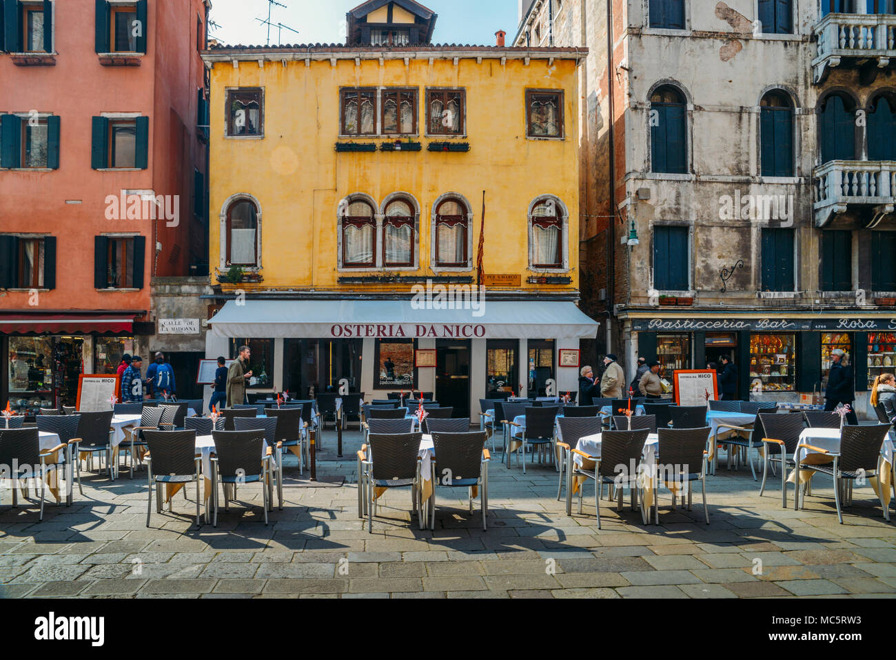 Venice, Italy - March 26th, 2018: Empty restaurant tables on the sidewalk in Venice Stock Photo