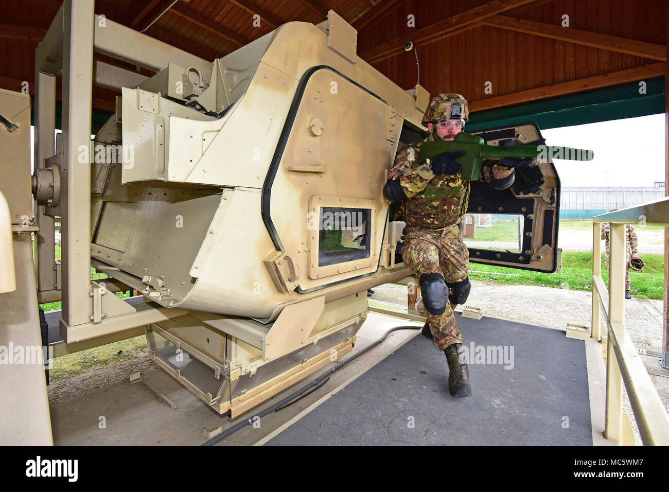 An Italian Army Paratrooper assigned to Regiment “Savoia Cavalleria” Folgore Brigade Grosseto, conduct training using High Mobility Multipurpose Wheeled Vehicle (HMMWV) egress assistance trainer (HEAT), at Caserma Ederle Vicenza, Italy, March 29, 2018. The simulator allows soldiers to practice exit from vehicles, skills and engage in realistic scenarios. Italian Paratroopers use U.S. Army RTSD South equipment to enhance bilateral relations and to expand levels of cooperation and the capacity of the personnel involved in joint operations. Stock Photo