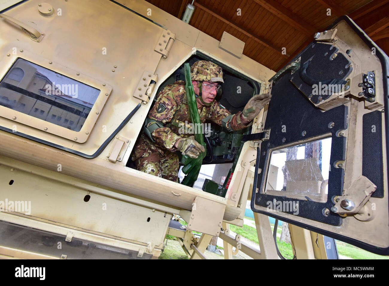 An Italian Army Paratrooper assigned to Regiment “Savoia Cavalleria” Folgore Brigade Grosseto, conduct training using High Mobility Multipurpose Wheeled Vehicle (HMMWV) egress assistance trainer (HEAT), at Caserma Ederle Vicenza, Italy, March 29, 2018. The simulator allows soldiers to practice exit from vehicles, skills and engage in realistic scenarios. Italian Paratroopers use U.S. Army RTSD South equipment to enhance bilateral relations and to expand levels of cooperation and the capacity of the personnel involved in joint operations. Stock Photo
