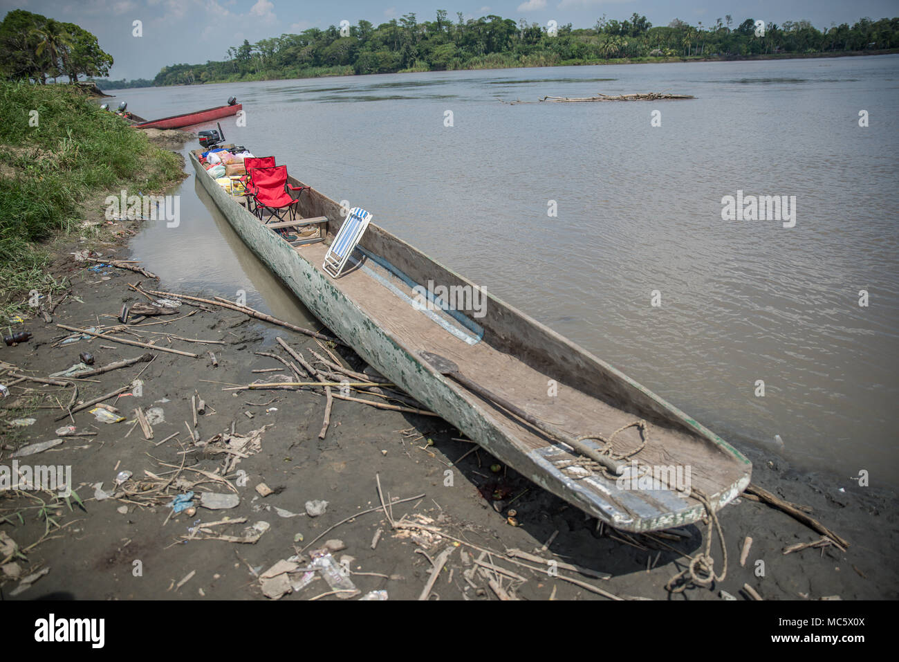 Dugout canoe with outboard motor and metal chairs, Pagwi, East Sepik Province, Papua New Guinea