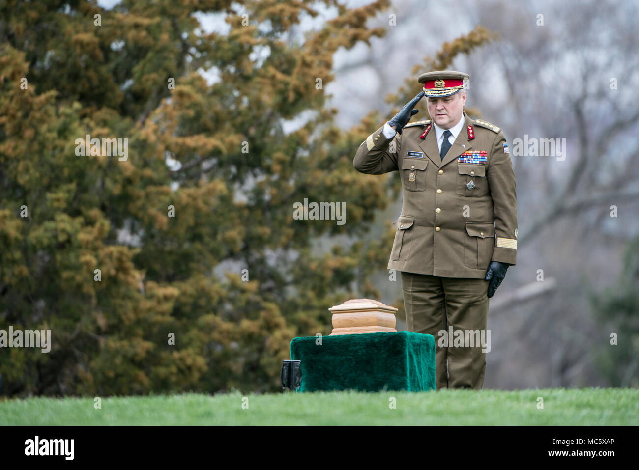 Estonian Gen. Riho Terras, Commander of the Estonian Defence Forces, renders honors during the full honors funeral of U.S. Army Col. and Estonian Gen. Aleksander Einseln in Section 34 of Arlington National Cemetery, Arlington, Virginia, April 2, 2018.  Born in Estonia, Einseln immigrated to the United States in 1949 and enrolled in the U.S. Army in 1950 at the outbreak of the Korean War. He served with Special Forces in the Vietnam War and retiring as a Colonel in 1985. In 1993, Einseln returned to Estonia at the request of Estonian President Lennart Meri to serve as the first commander of the Stock Photo