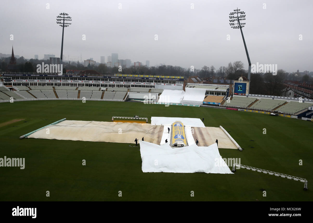 The ground staff move covers on to protect the wicket on the 1st day morning of the County season during the Specsavers County Championship Division Two match at Edgbaston, Birmingham. PRESS ASSOCIATION Photo. Picture date: Friday April 13, 2018. See PA story CRICKET Warwickshire. Photo credit should read: Nick Potts/PA Wire. RESTRICTIONS: Editorial use only. No commercial use without prior written consent of the ECB. Still image use only. No moving images to emulate broadcast. No removing or obscuring of sponsor logos. Stock Photo