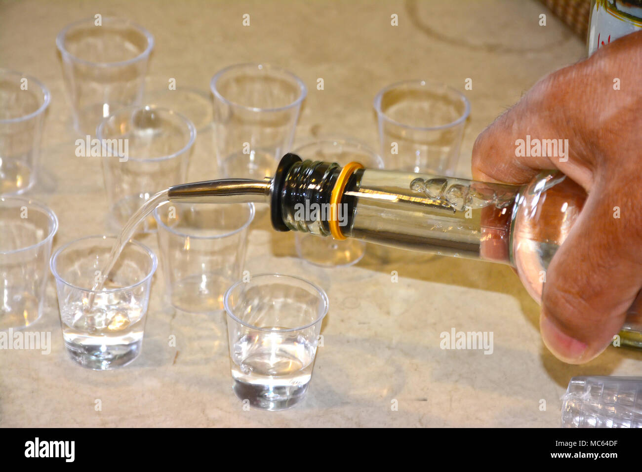Pouring Arak into glasses Stock Photo