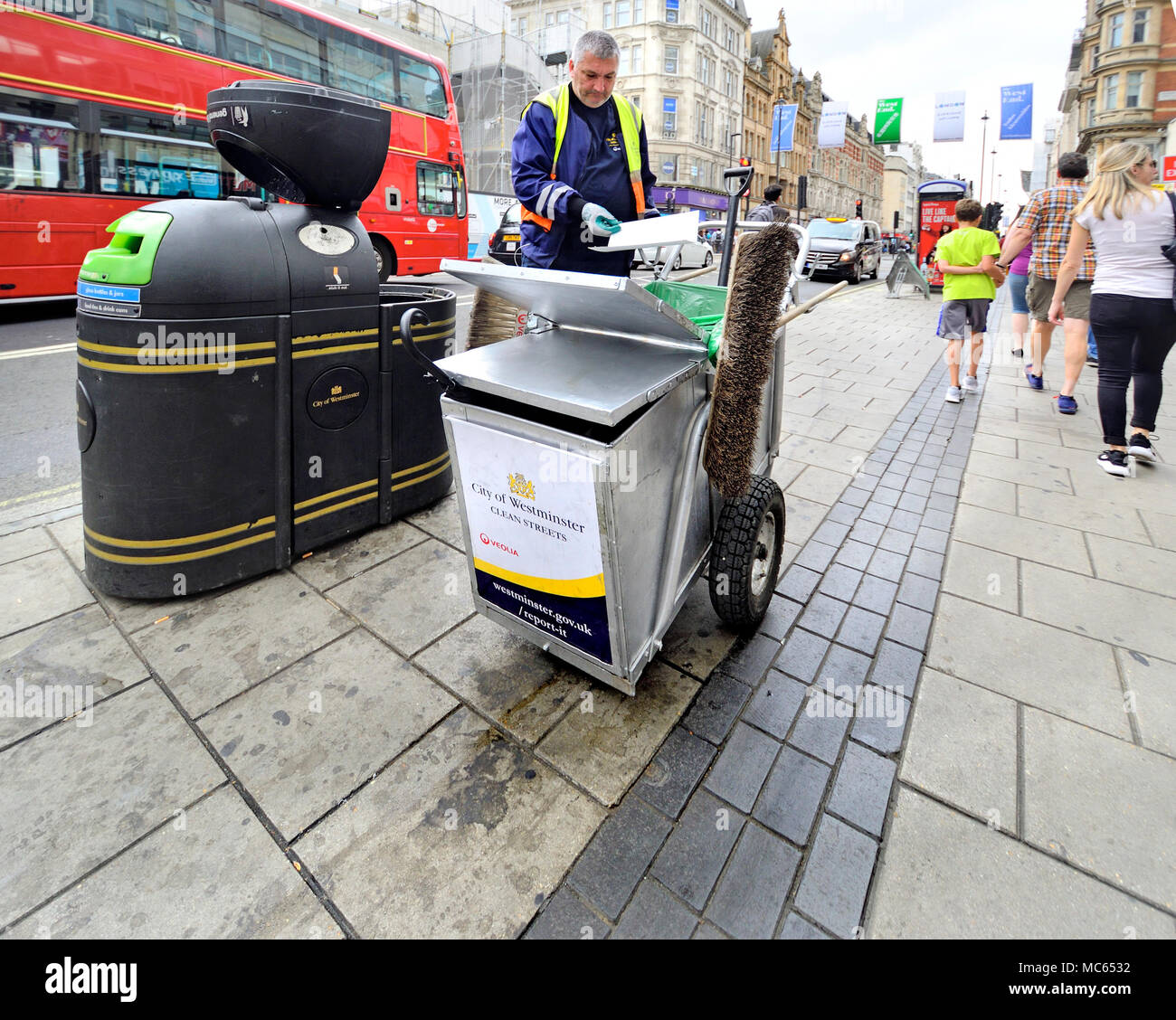 London, England, UK. Street sweeper emptying bins in Regent Street