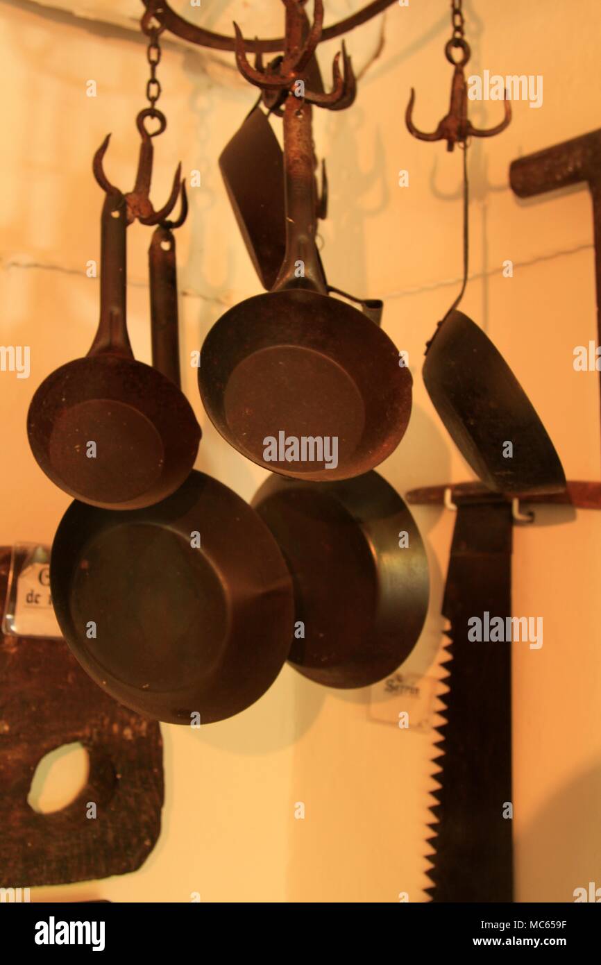 Cast iron pans hanging in an old Alpujarran home, Granada, Andalusia, Spain  Stock Photo - Alamy