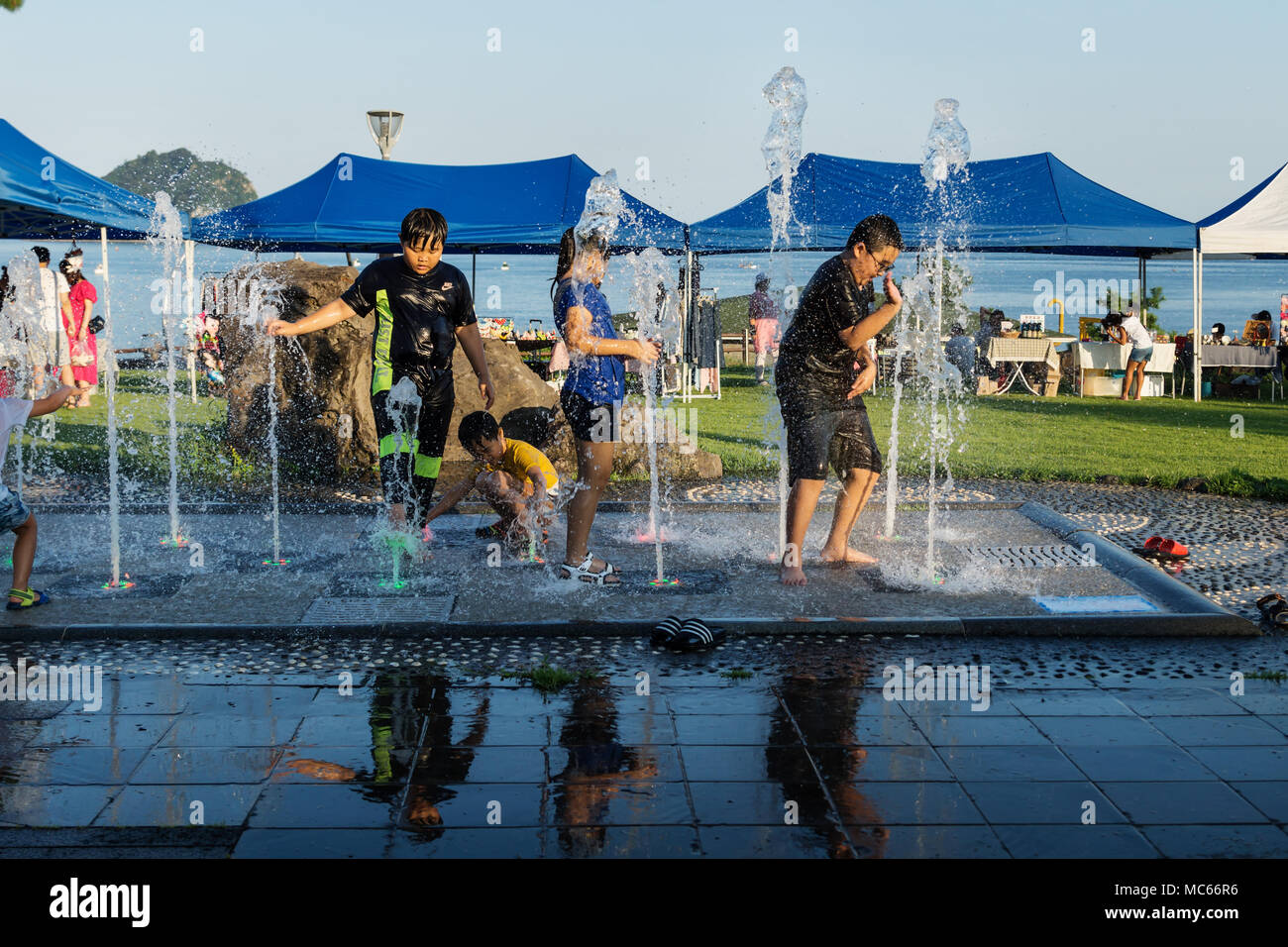 Seogwipo, Jeju Island, Korea - August 27 2017: Korean boy hitting water in a fountain Stock Photo