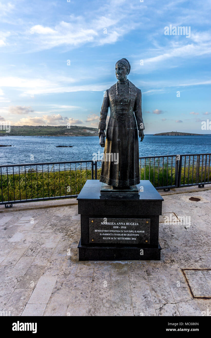 Statue of Markiza Anna Bugeja  with views across St Pauls Bay, Bugibba, Malta, Europe Stock Photo