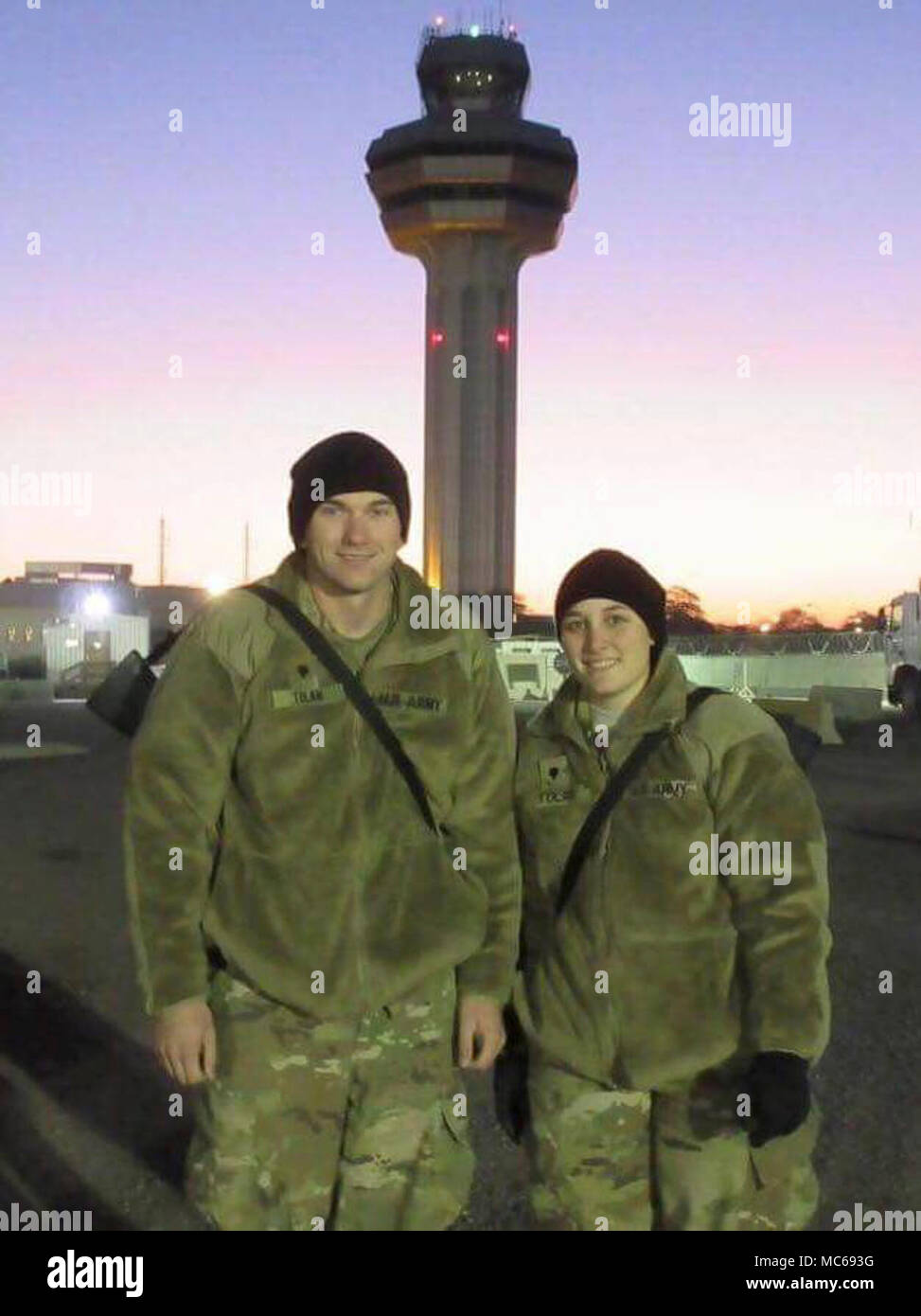 KUWAIT CITY, Kuwait -- U.S. Army Spc. Austin Tolan, a sheet metal repairer assigned to B Company, 248th Aviation Support Battalion, 449th Combat Aviation Brigade poses for a photo with his wife, Spc. Taylor Tolan, a hydraulics mechanic assigned to B Company, 248th Aviation Support Battalion, 449th Combat Aviation Brigade after arriving at Kuwait International Airport Dec. 12, 2017. The Tolans are currently serving overseas together in the U.S. Army Central Command area of responsibility in support of Operations Inherent Resolve and Spartan Shield. Stock Photo