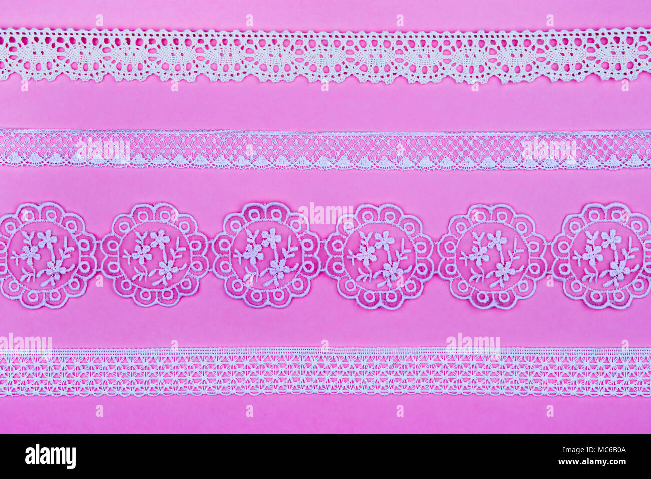 4 different lace borders against pink background. Stock Photo