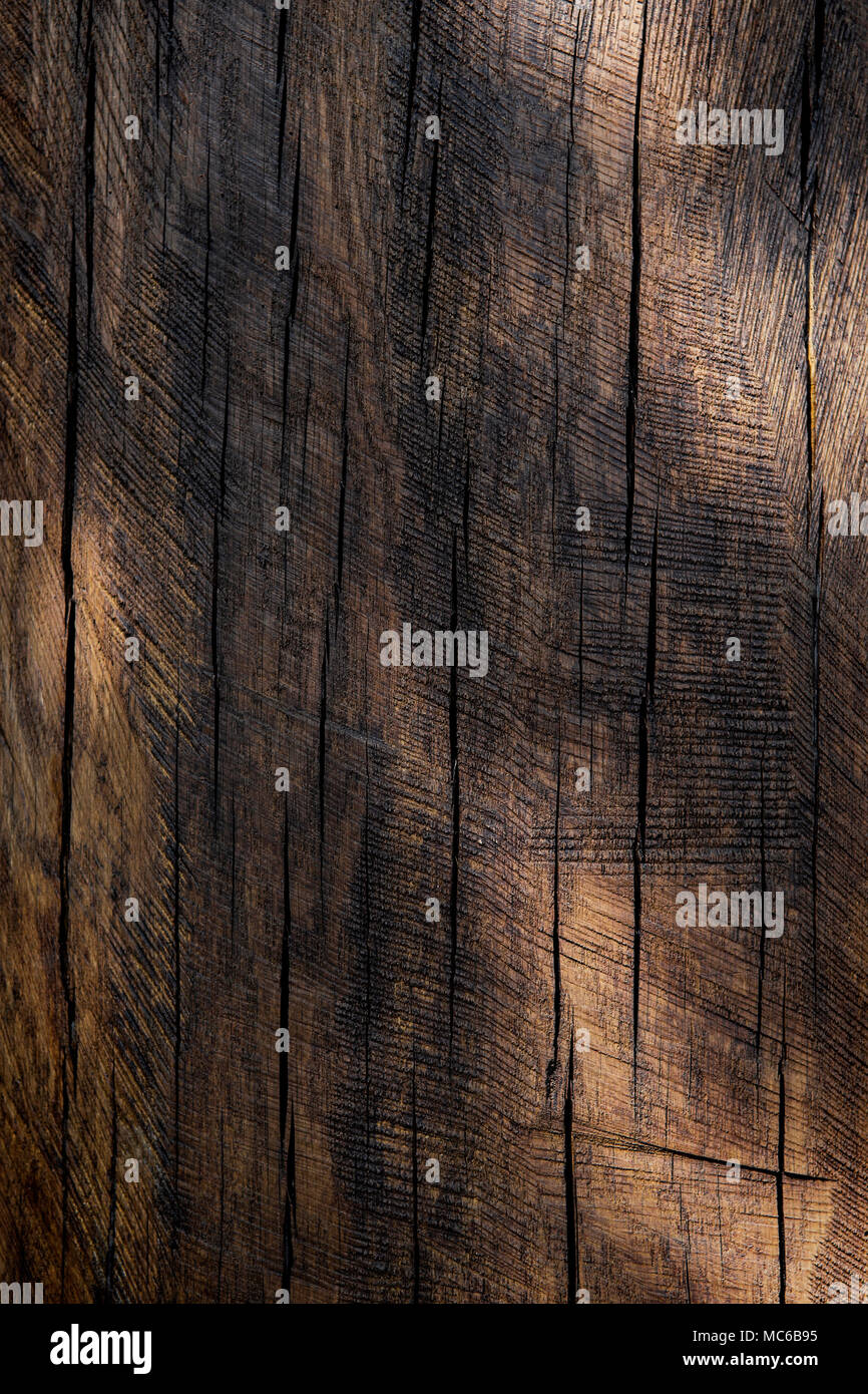 A rich old dark wood background with natural spots of light spread across it. Stock Photo