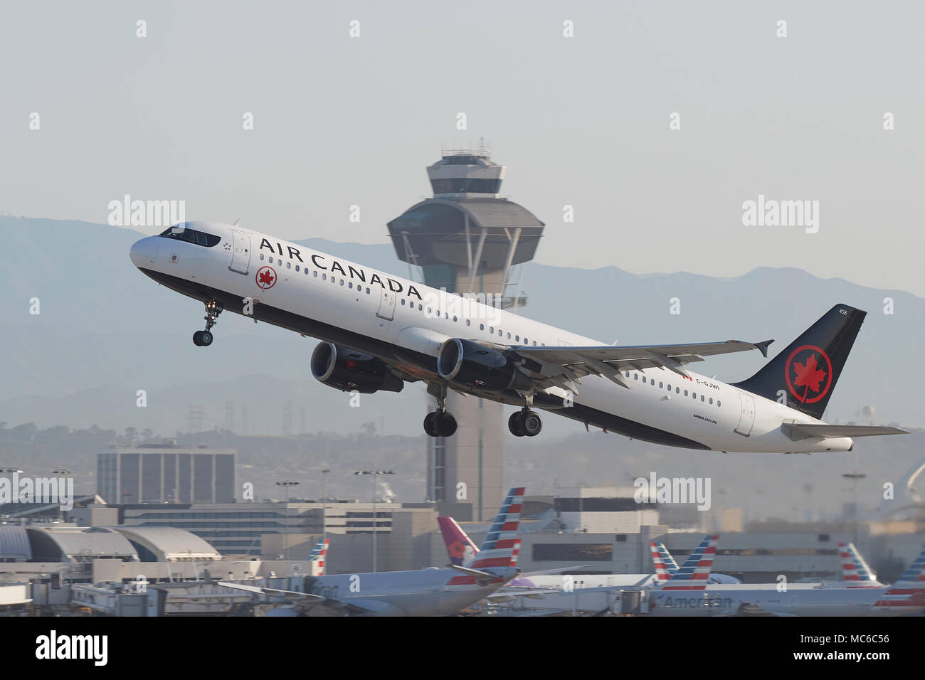 Air Canada Airbus A321 Jet, In The New Livery, Taking Off From Los Angeles International Airport, LAX. The ATC Control Tower In Background. Stock Photo