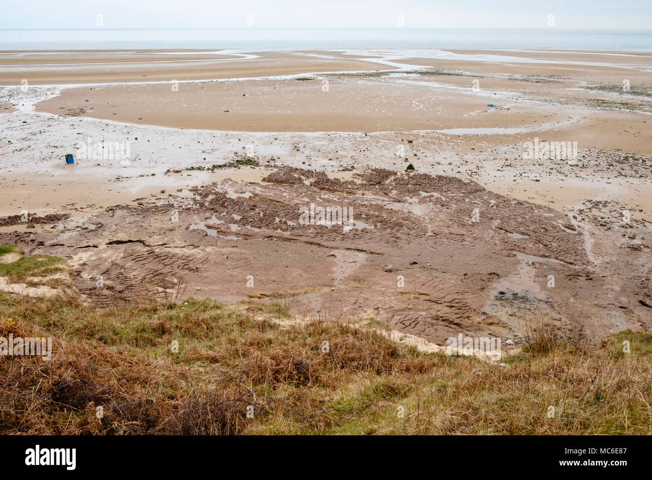 Dangerous soft sand forming quicksand seen from above on the beach at