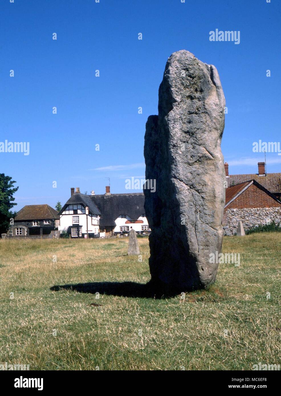 Stones - One of the great uprights at the stone circles of Avebury. The village of Avebury was partly built into this S-E circle, and in some cases the stones were broken up to make building material Stock Photo