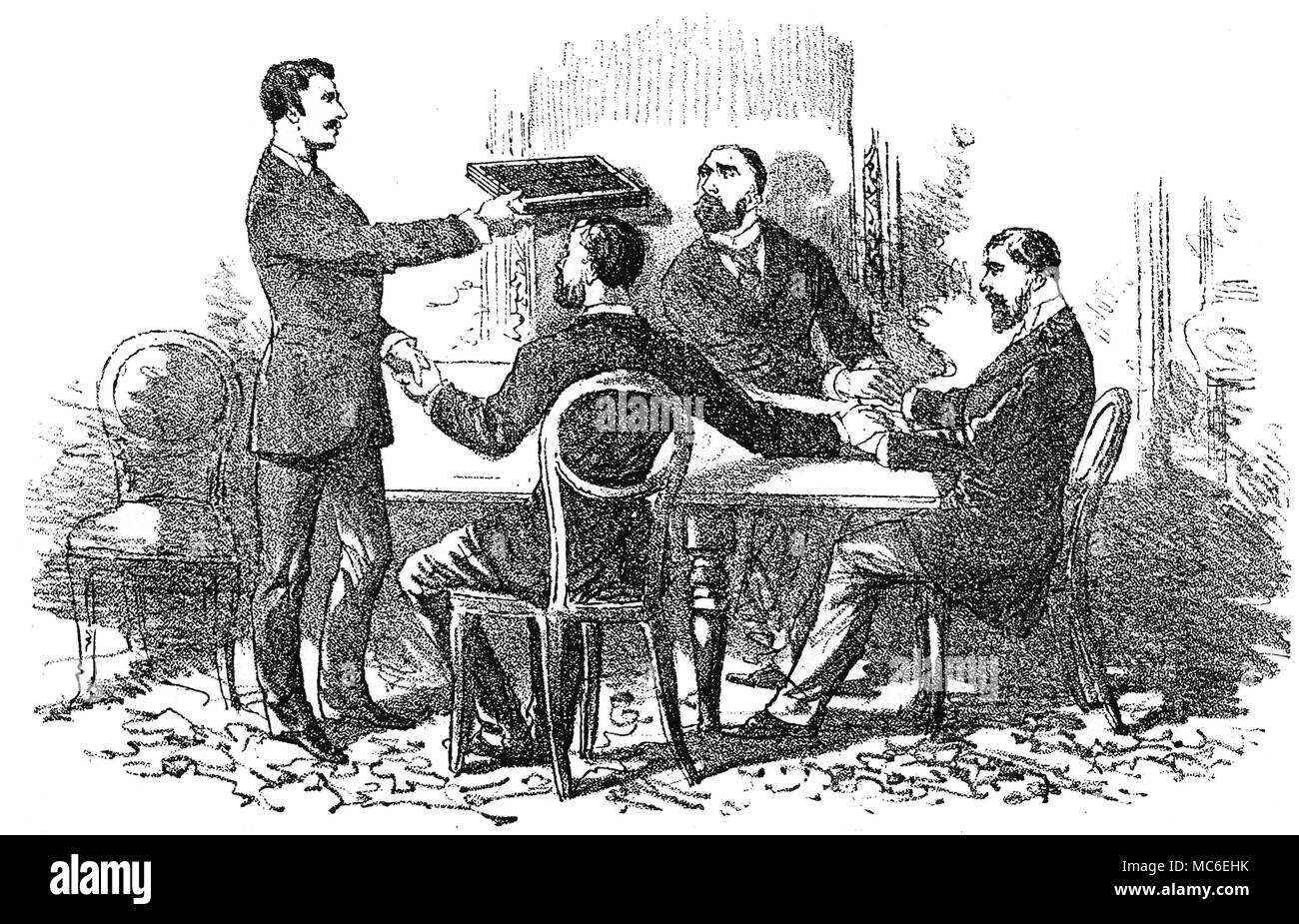 SPIRITUALISM, SEANCES AND SLATE WRITING - EGLINGTON Lithograph showing the method of obtaining spirit writing on two slates, held over the sÃšance table. 'The actual production of the (spirit) writing without visible agency has also been witnessed', and in almost every case the sound of writing being done by an invisible agency is heard during the sÃšances. From John S. Farmer, Twixt Two Worlds. A Narrative of the Life and Work of William Eglington, 1886. Stock Photo