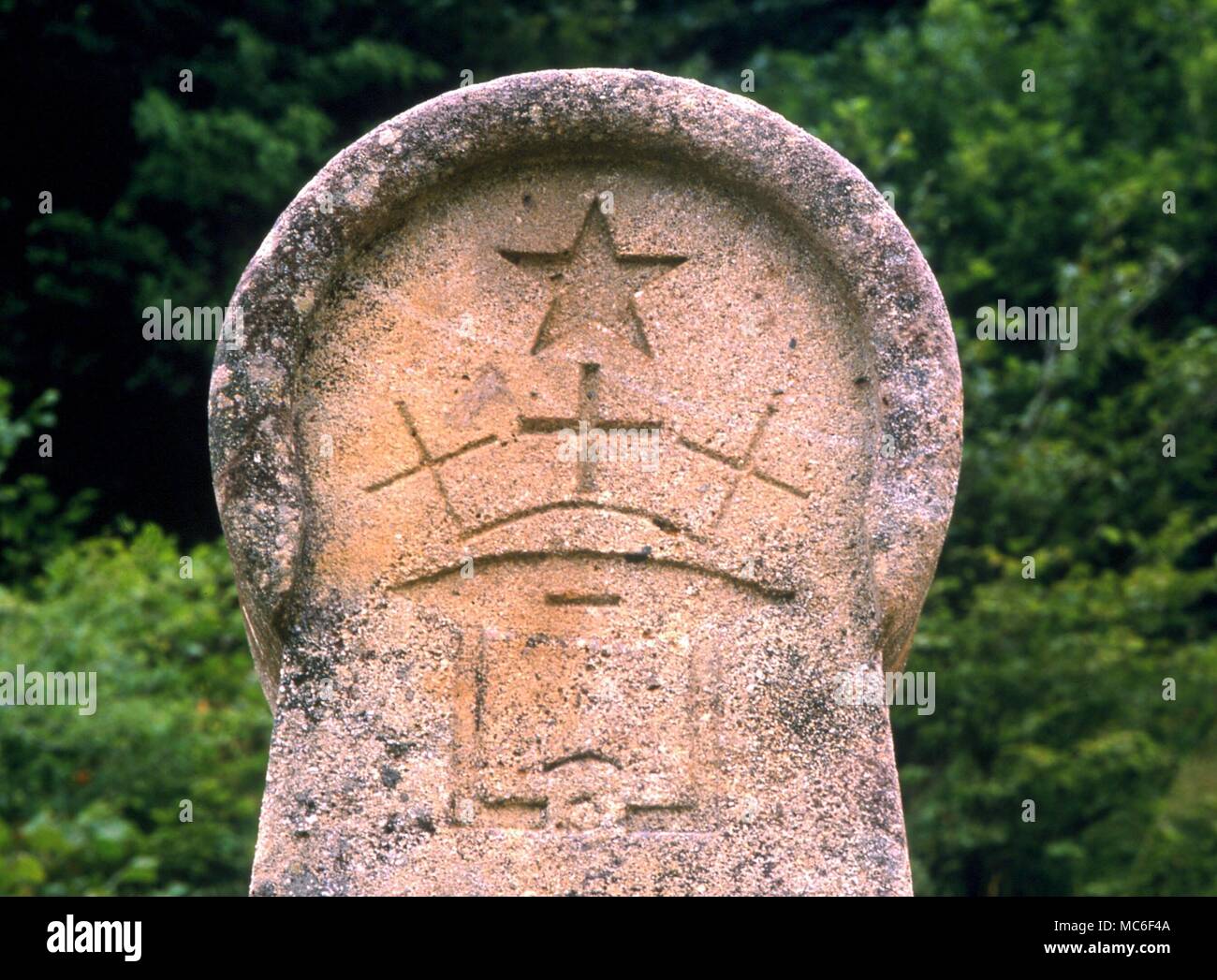 Etheric The five-pointed star (symbol of the etheric) above the cross, as symbol of the risen Christ. Bas relief on the memorial to those executed at Montsegur in mediaeval times. Montsegur, France Stock Photo