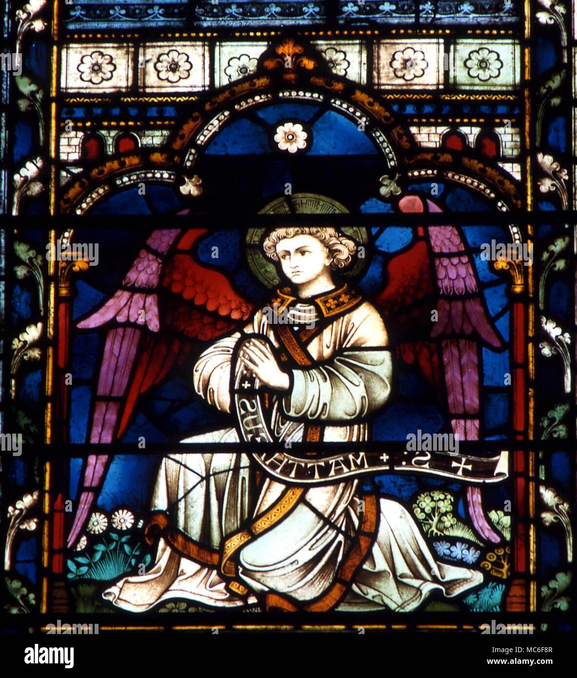 SAINTS - St Matthew, represented as his symbol, derived from astrology (Aquarius, the water-pourer as a winged man. The'water' has become Word of God. Stained glass of the 19th century, from cathedral at Southwell Stock Photo