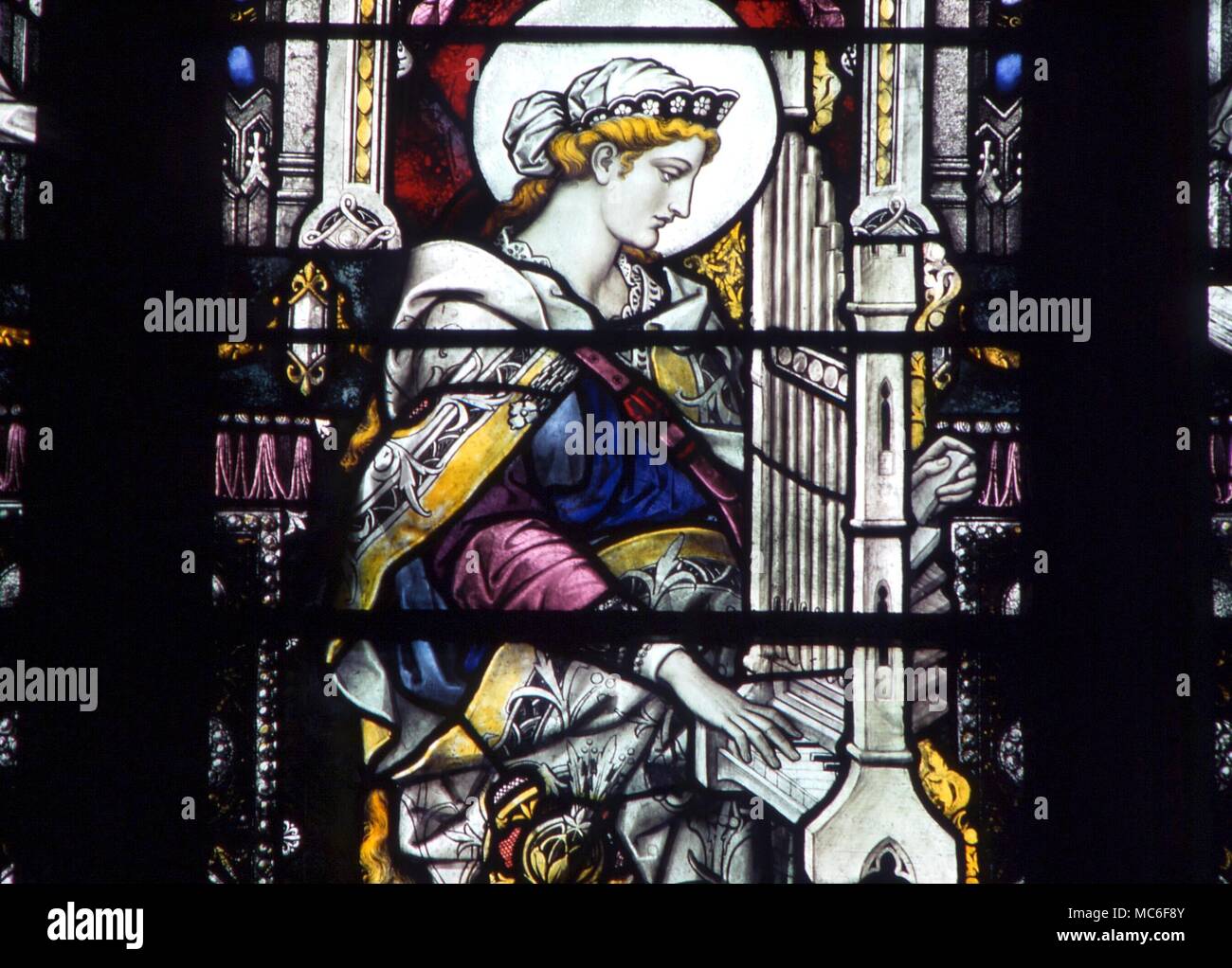 SAINTS - St Cecilia at the organ (she is patron saint of music). Stained glass in the north wall of St Margaret's Church, King's Lynn Stock Photo