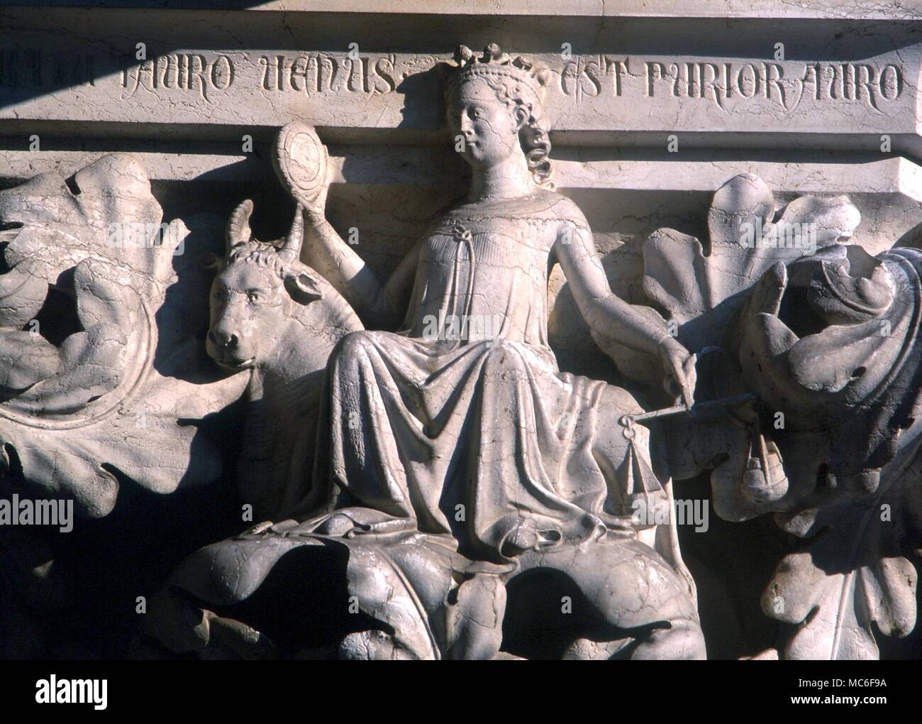 PLANETS - VENUS Personification of Venus sitting on the zodiacal Bull, (ruled by Venus), holding the balance of Libra, and admiring herself in the mirror. Statuary detail on the capital of the south-western column of the Doge's Palace, Venice. 15th century? Stock Photo