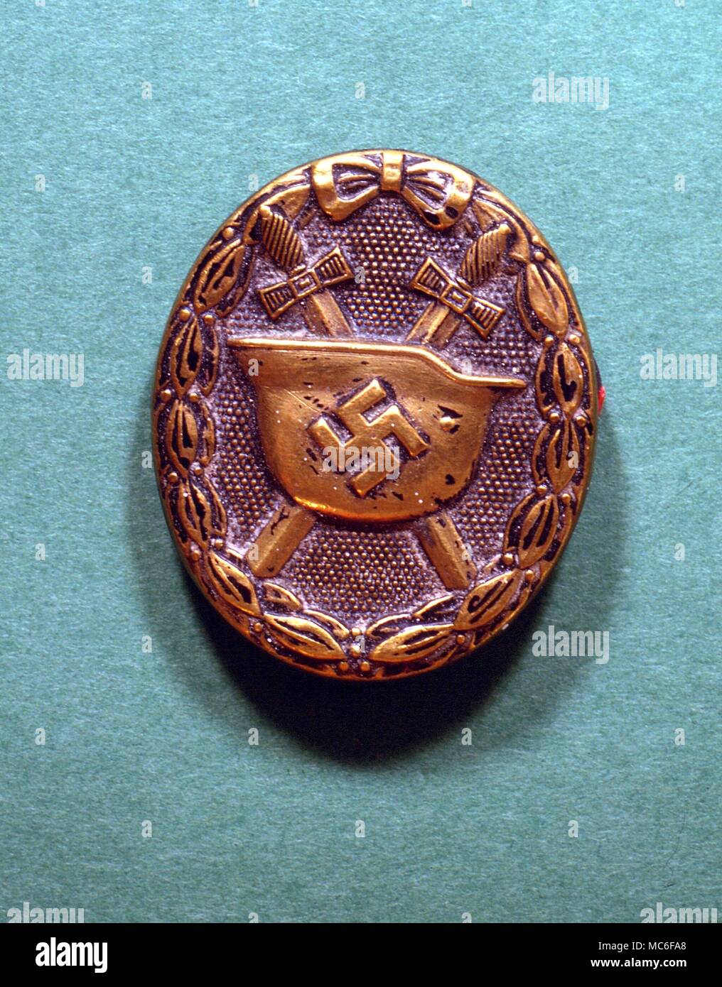 SWASTIKA, helmet and crossed swords on a Nazi army badge Stock Photo