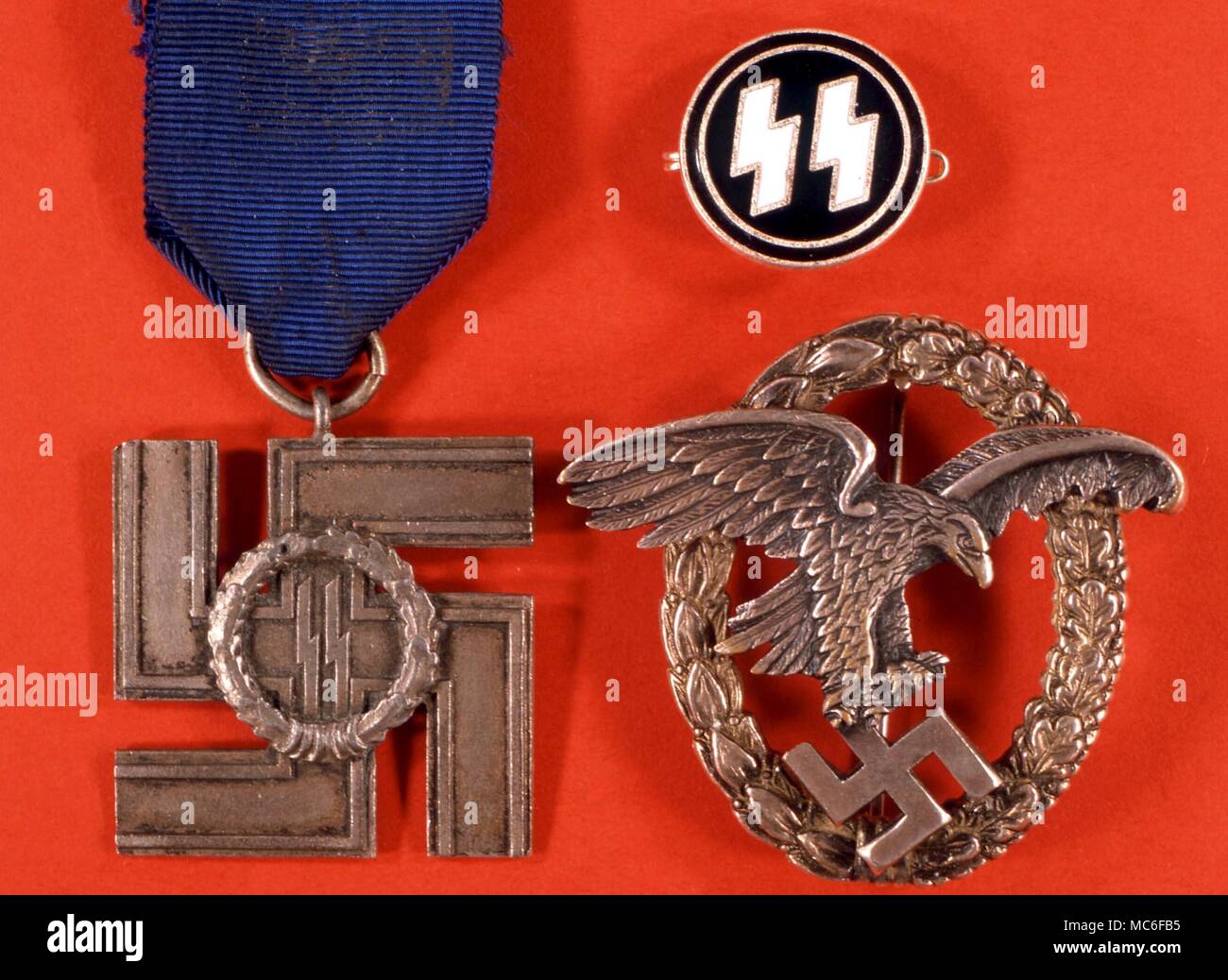 SWASTIKA Swastika in the talons of an eagle. Nazi service medal - Observer's Badge. Swastika on cross, with SS (runic) symbol: SS Service Medal, First and Second Class. Small SS members badge Stock Photo