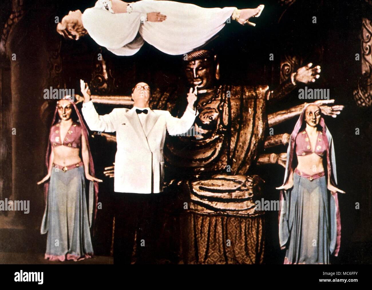 Levitation. Kalanag (Helmut Schreiber, 1903-1963) German international illusionist, levitates his wife Gloria in a spectular scene from his show 'Sim Sala Bim' Stock Photo