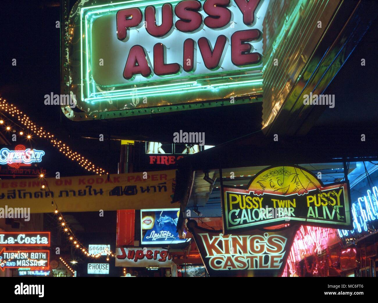 Neon light advertisements in the Red Light district of Bangkok, with the image of a cat advertising prostitutes Stock Photo