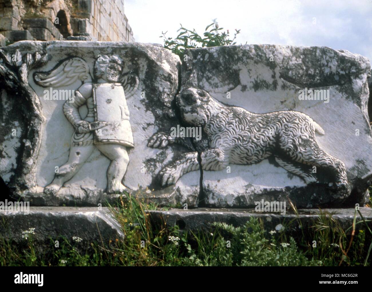 ANIMALS - Bear attacking a gladiator in the Roman arena. bas relief on fallen masonry in front of the Roman theatre at Miletus, Turkey Stock Photo