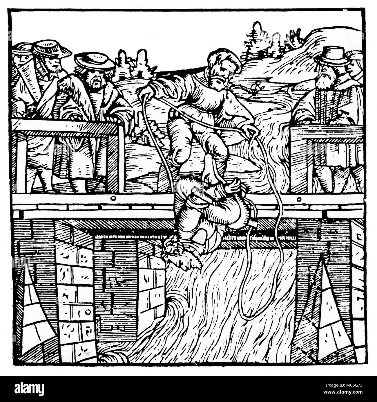 WITCHCRAFT - SWIMMING It is unclear from this woodcut whether the victim is being 'swum' - that is, thrown into the waters to see if he will sink or swim, and thus reveal his guilt - or whether he is merely being drowned, as punishment for being a witch. Woodcut of circa 1505. Stock Photo
