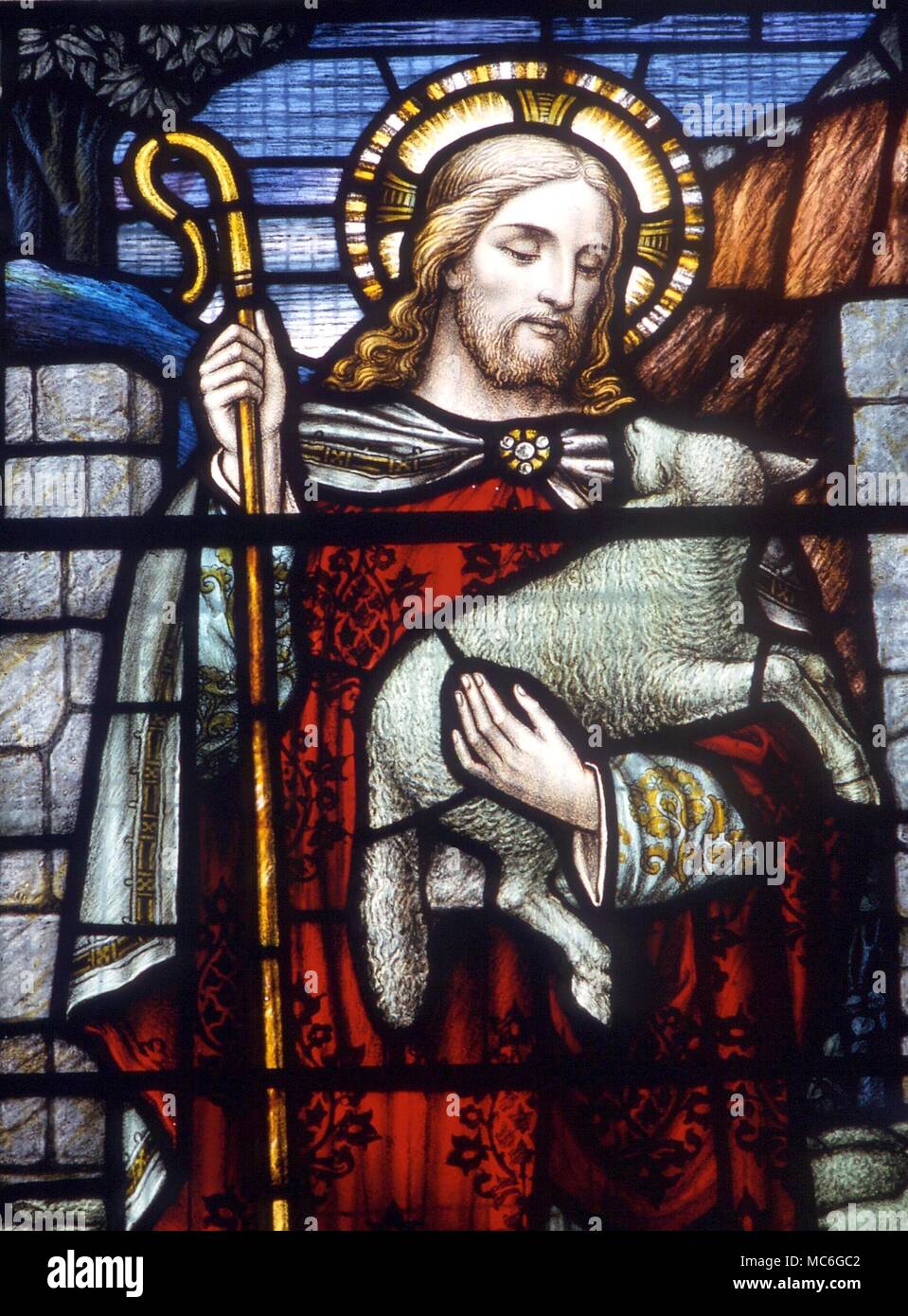 The Lamb of God - stained glass image of the 19th century, of Jesus as shepherd, carrying the lost lamb. From a window in church at Newchurch in Pendle, Lancashire Stock Photo