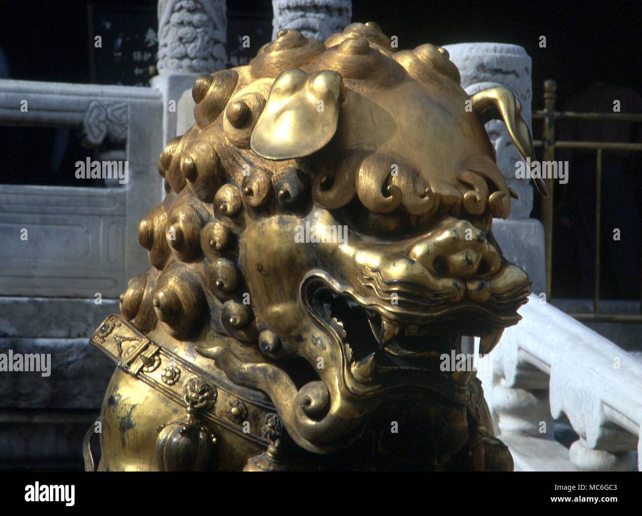 Guardian lion, its foot resting on the pearl in the Forbidden City, Beijing Stock Photo