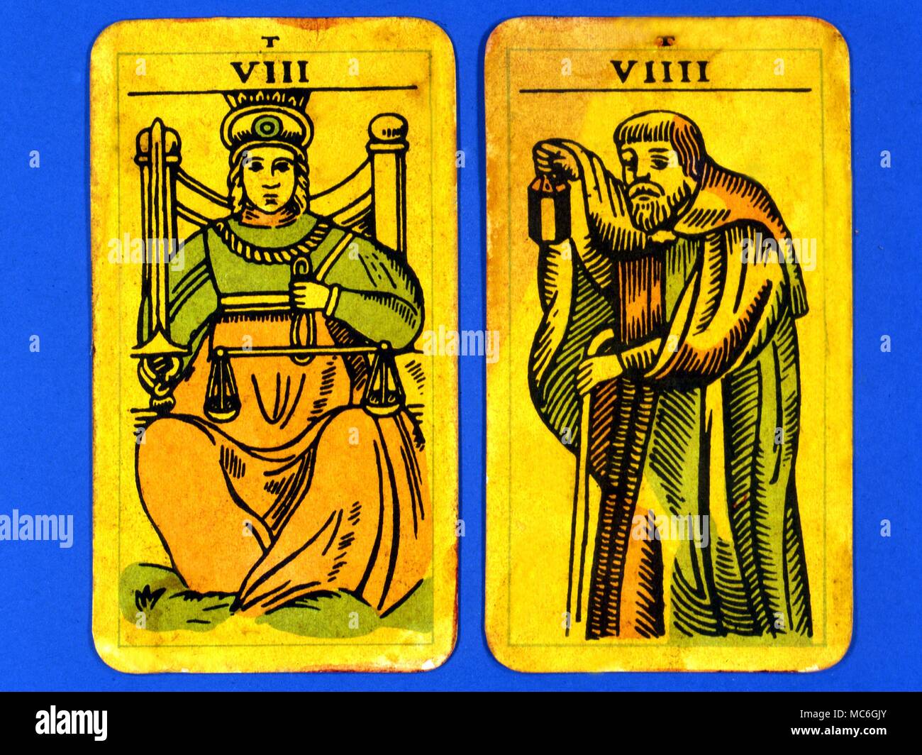 Tarot Cards-Majo Arcana- The Parisian Tarot. Card 8.The Justice, and Card 9.. The Hermit. Two cards from a Major Arcana picture Tarot,adapted by a Wiccan group. Probably designed in an archaizing style in loose imitation of the Rosicrucian deck designed by Pamela Coleman Smith, alongside A.E.Waite, and various earlier decks, such as that published by Encausse (Papus) in The Tarot of the Bohemians at the end of the 19th century, post 1905, but earlier than 1912. The name Parisian Tarot was given by the owner of the deck - it might however be called the Tau Tarot, from the intriguing letter Tau Stock Photo