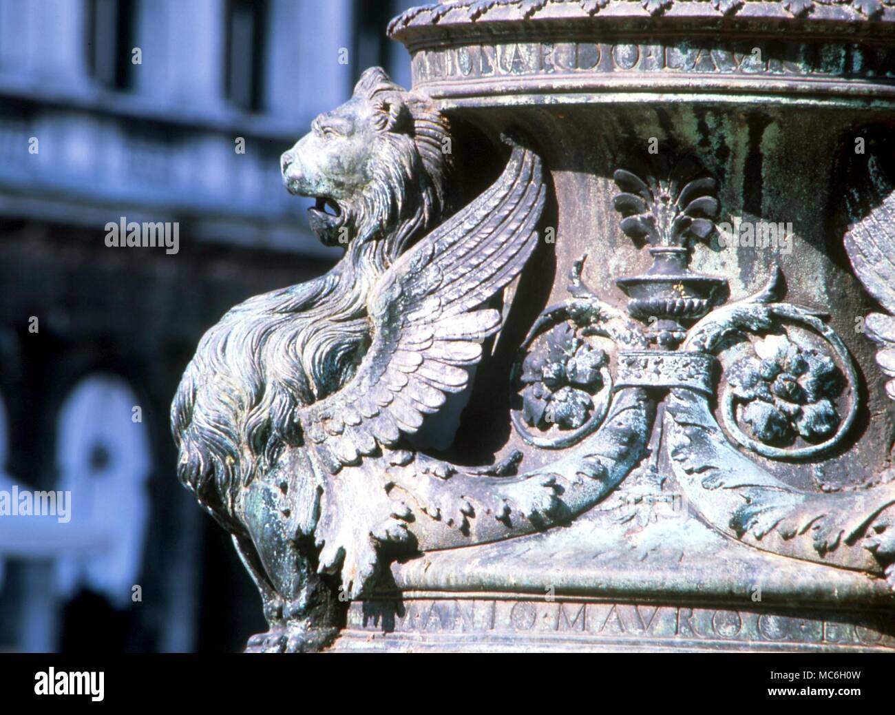 MONSTERS - Lion-headed bird with curled tail. Emblem on lamp post in San Marco Square, Venice Stock Photo