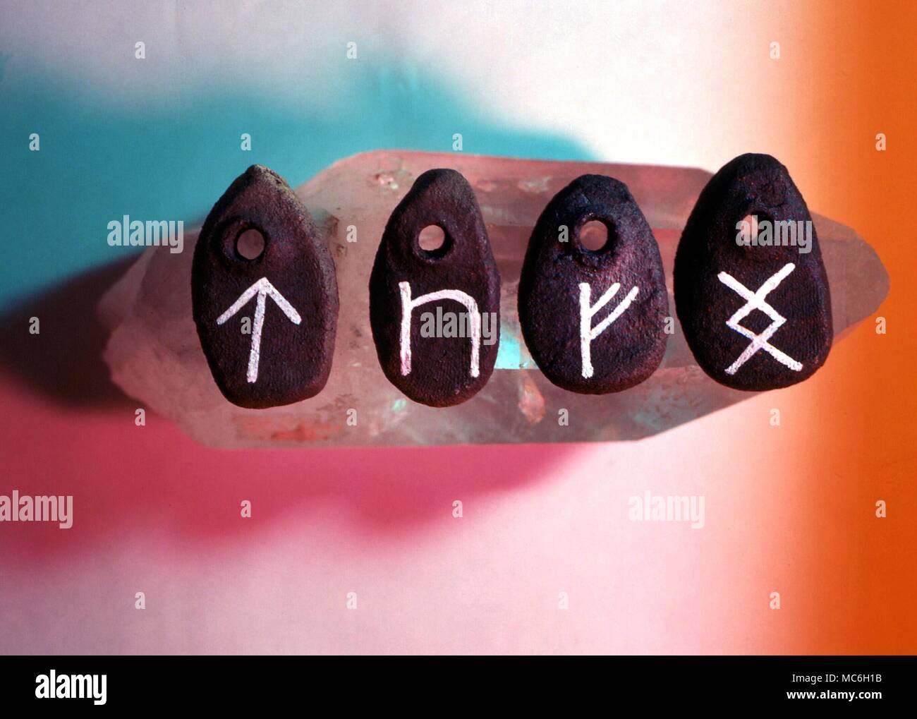 The rune stones for Tir (tree), Peord (horse), Feoh (wealth) and Ing (meaning unsure) Stock Photo