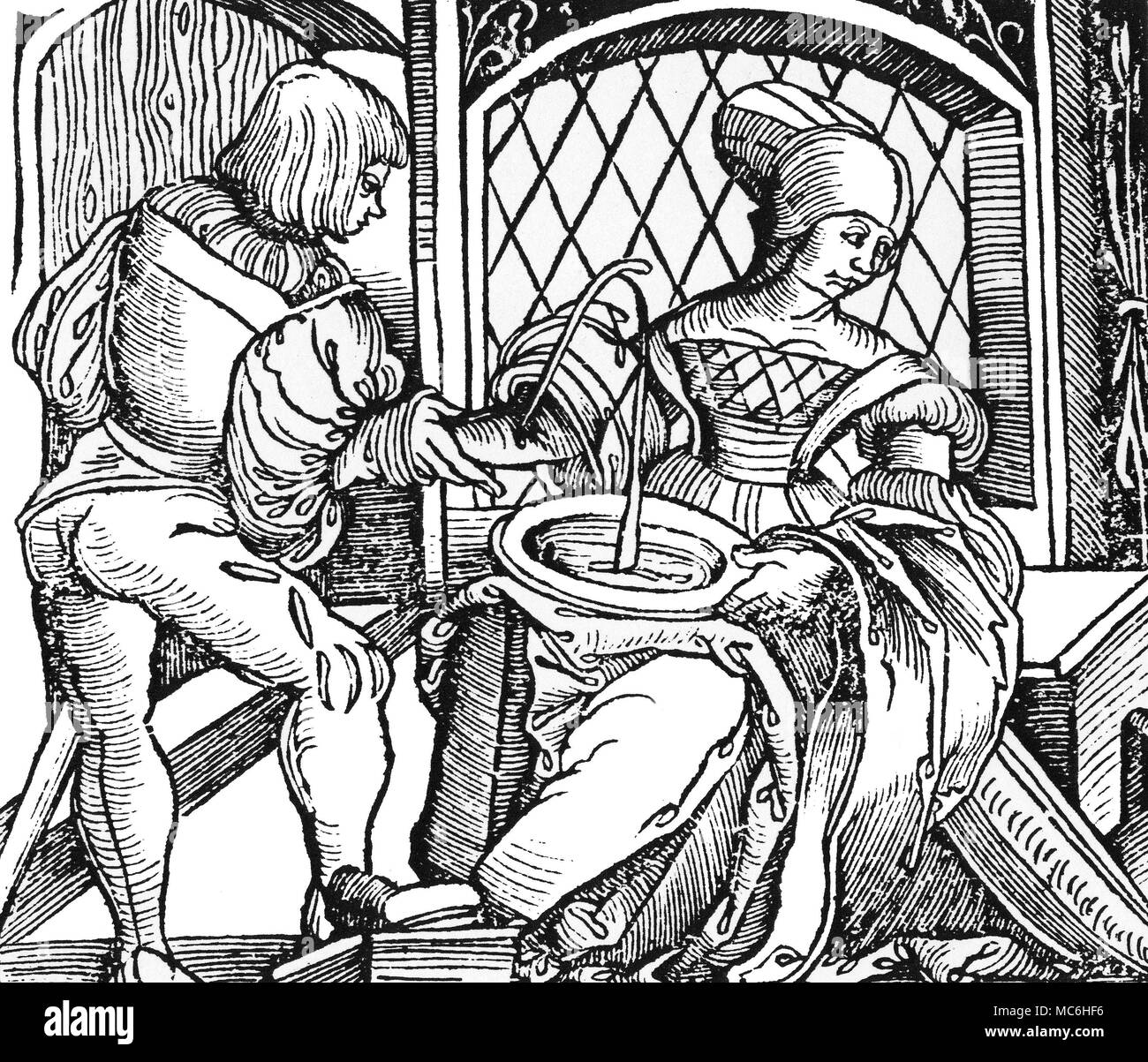 MEDICAL - BLOODLETTING Sixteenth-century doctor bleeding a woman - the type of medicine which Nostradamus practised. From the 1532 edition of Der Schapherders Kalender. Stock Photo