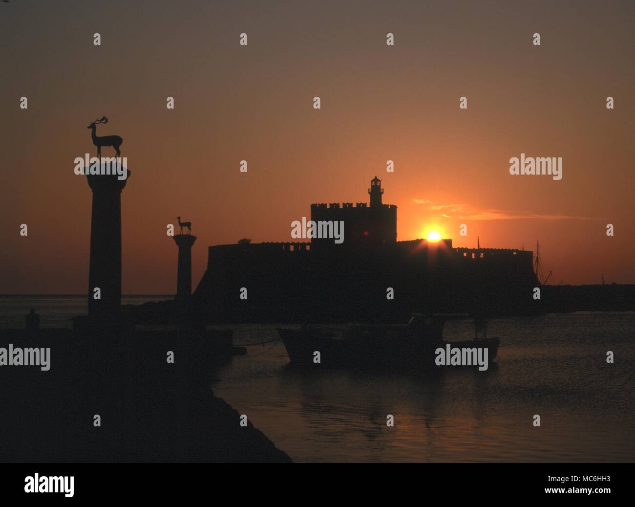 Light Mysteries. Sunlight over the Port of Rhodes in Greece, where in antiquity stood the world wonder of the statue of the Sun God, Helios. He greeted the sunrise with his own earthly flames Stock Photo